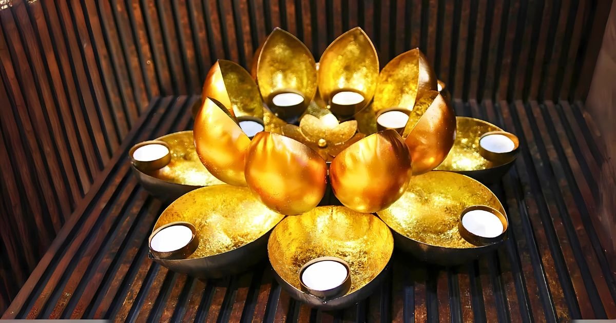 Gold lotus-style tea light candle holder with eight surrounding cups or petals for candles